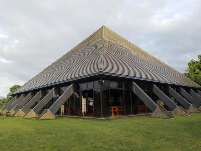 pyramid shaped building in lush outdoor setting